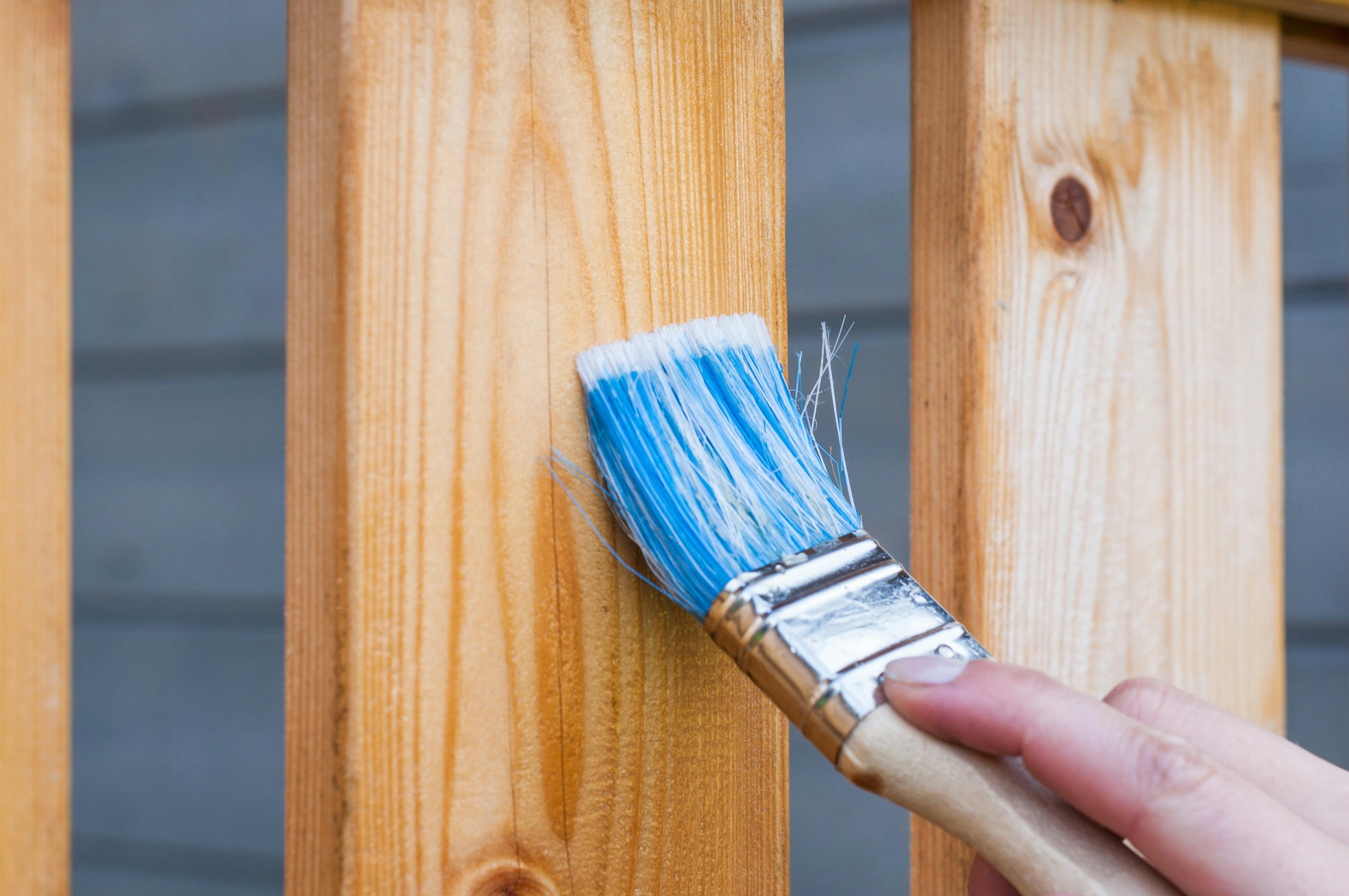 blue paint brush on wood