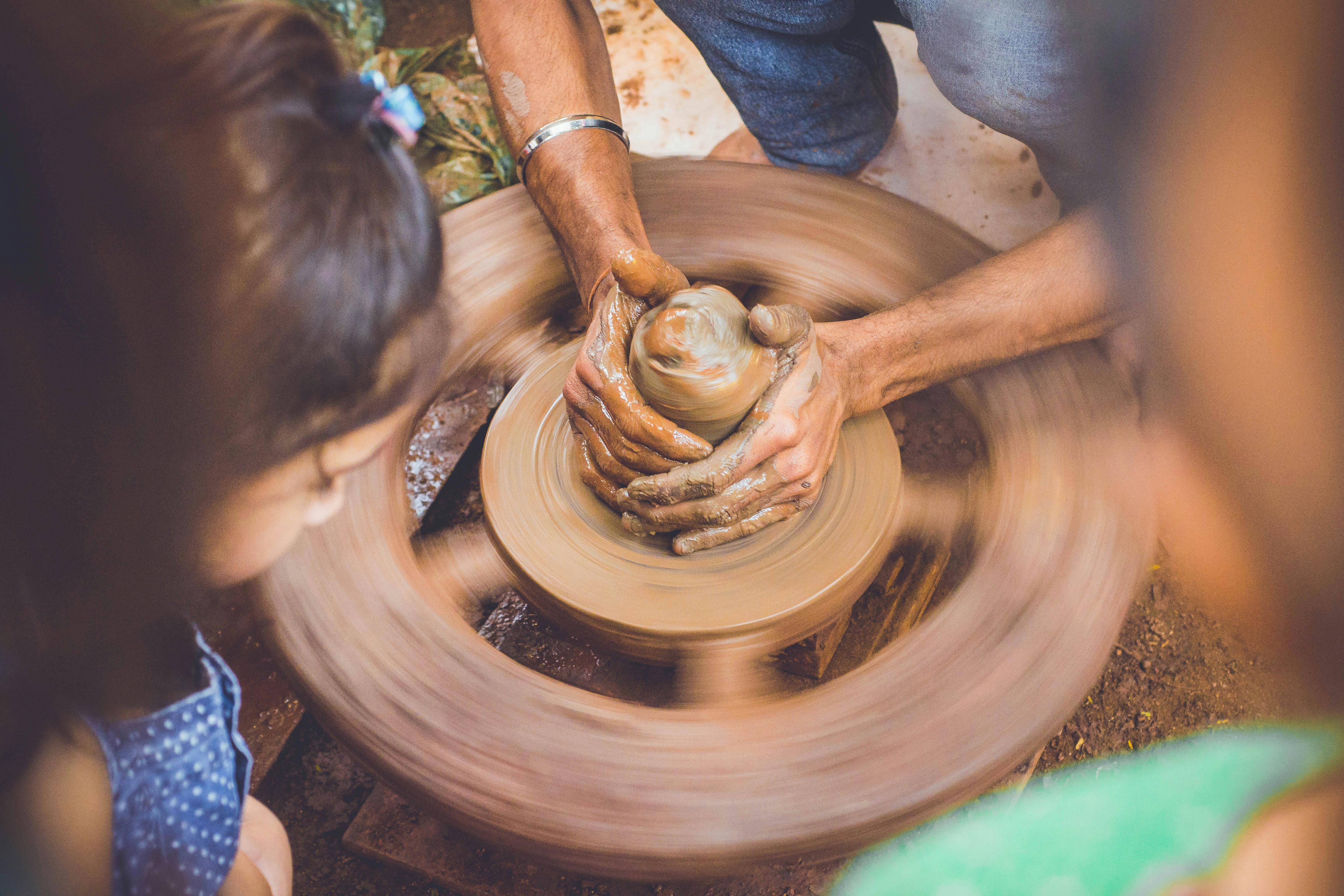 resilience Person Making Clay Pot in Front of Girl during Daytime